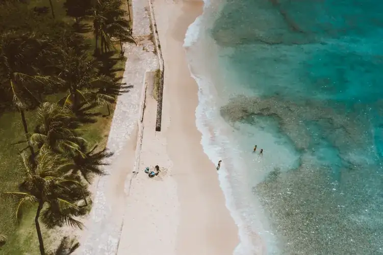 Aerial view of a bright blue tropical beach in Hawaii