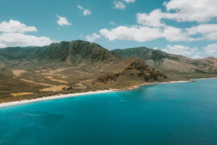 Aerial view of a Hawaiian island coastline with bright blue water