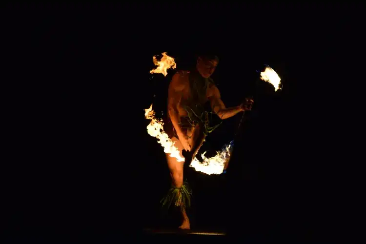 A fire-knife dancer performing at a Hawaiian luau on Oahu