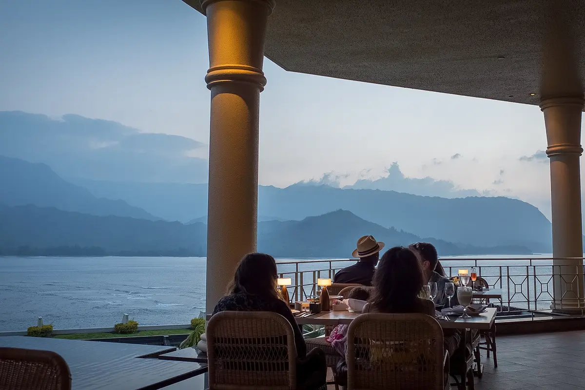 A sunset dinner on a terrace overlooking Hanalei Bay, one of the best restaurants in Kauai