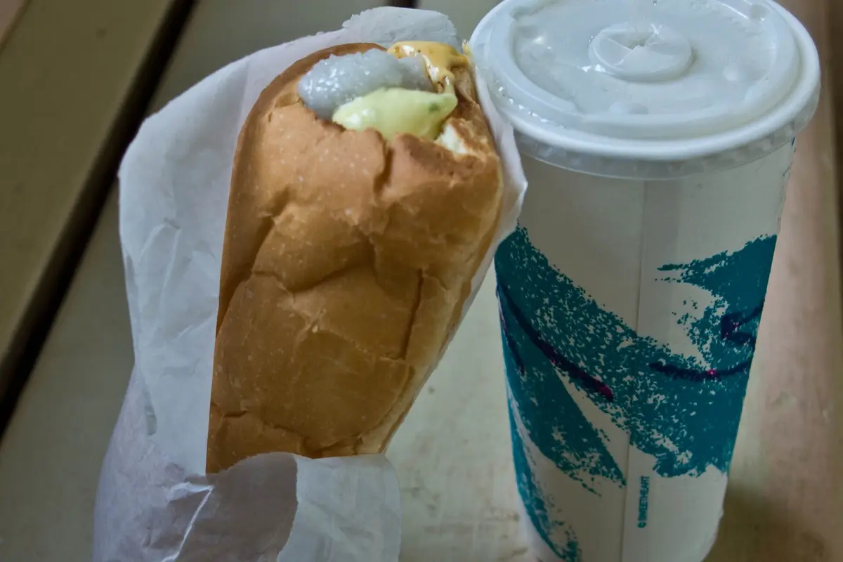 A Puka Dog, the Kauai hot dog in a hole punched toasted bun with tropical relish