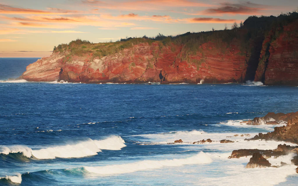 Red sea cliff and surf on the rugged West Maui coast near the Kahekili Highway