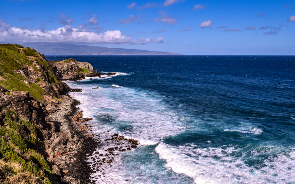 Rugged lava coastline and green sea cliffs along the West Maui shore on the Kahekili Highway Maui