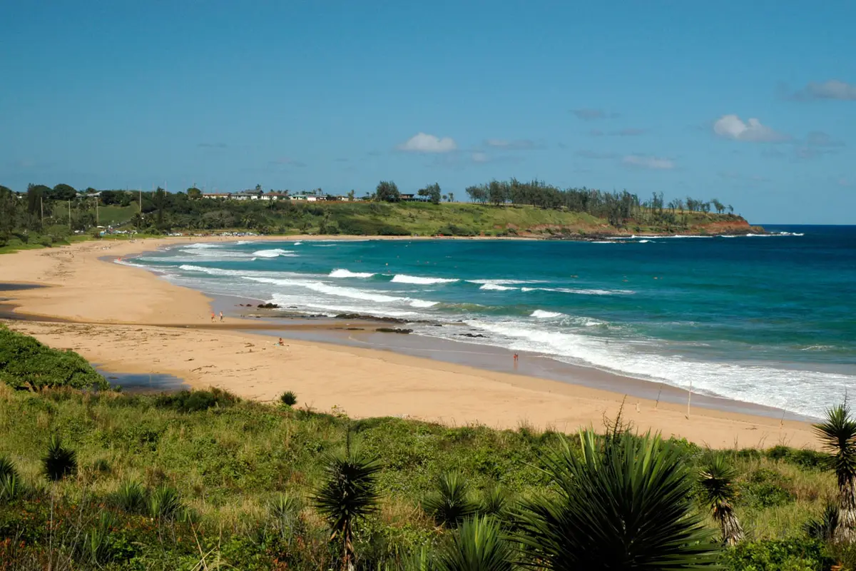 The view of Kealia Beach Kauai and its curving bay from the Kealia overlook on Kuhio Highway