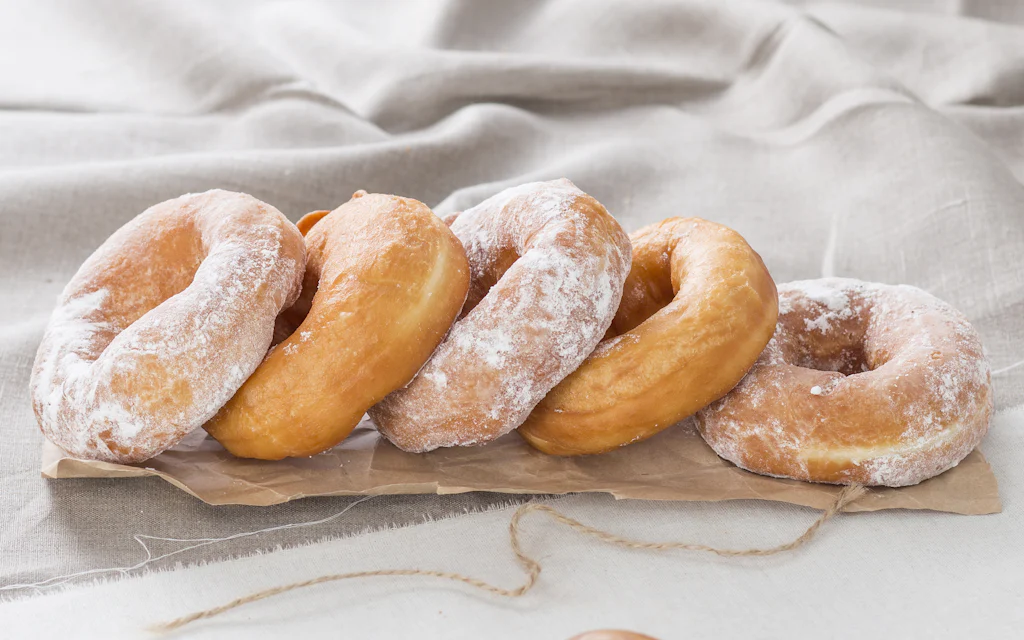 A sugar-dusted fried doughnut, similar to a Hawaiian malasada