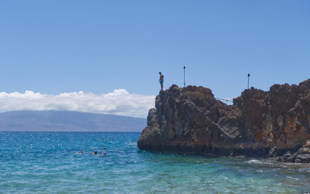 Black Rock lava point at the north end of Kaanapali Beach on the west coast of Maui, with turquoise water and snorkelers