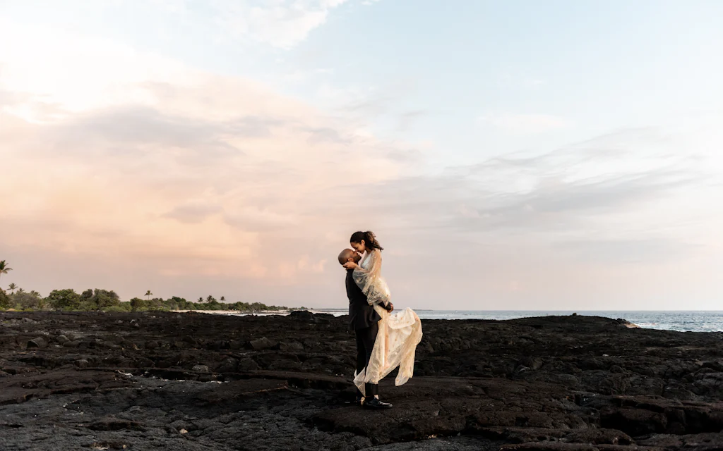A couple sharing a romantic moment on a Hawaii beach at sunset
