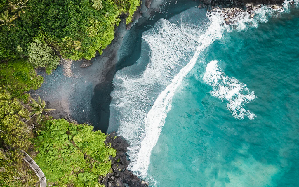 Aerial view of the black sand beach at Waianapanapa State Park on the Road to Hana, Maui