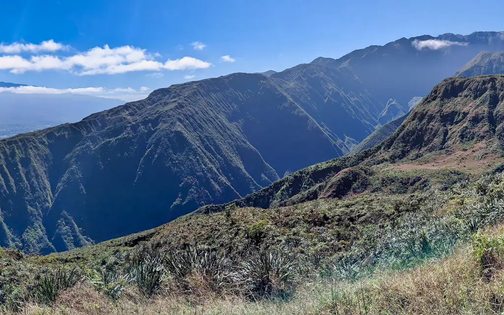 Grassy ridge looking across the fluted green West Maui Mountains on the Waihee Ridge Trail Maui