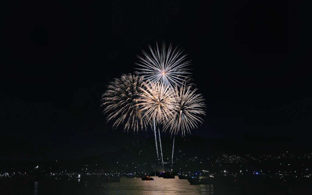 Fireworks over the water at night, like Waikiki's Friday show